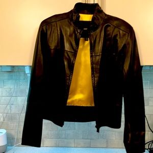 Beautiful and stylish black leather jacket with unique yellow/gold interior.